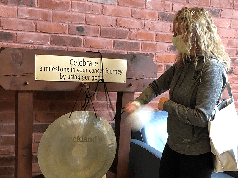 Photo: Ashley Howat ringing the gong at the WRHN Cancer Centre