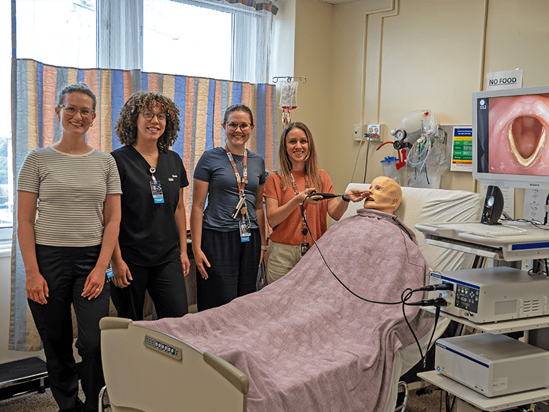 Photo: Flexible Endoscopic Evaluation of Swallowing (FEES) test - WRHN team members posing for a photo.