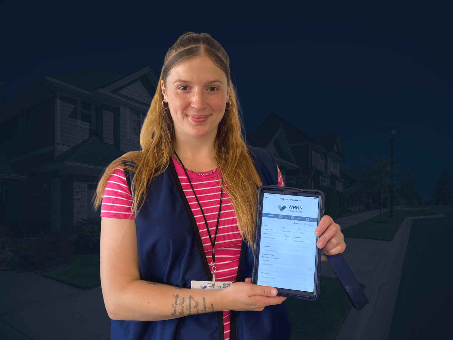 WRHN Foundation representative wearing a vest, ID badge, and carrying a tablet